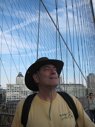 Stephen Greenfield walking over the Brooklyn Bridge